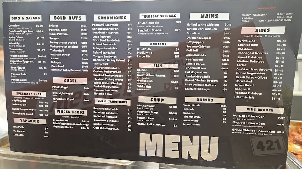 Printed menu with sandwiches and side dishes.
