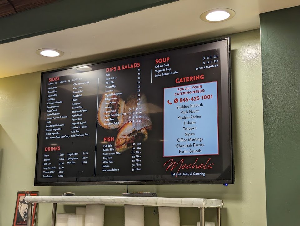 Menu board showing kosher takeout options.